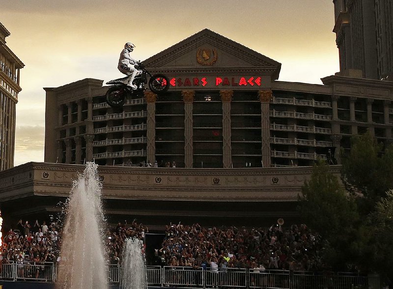 Travis Pastrana jumps the Caesars Palace fountain on a motorcycle Sunday in Las Vegas.