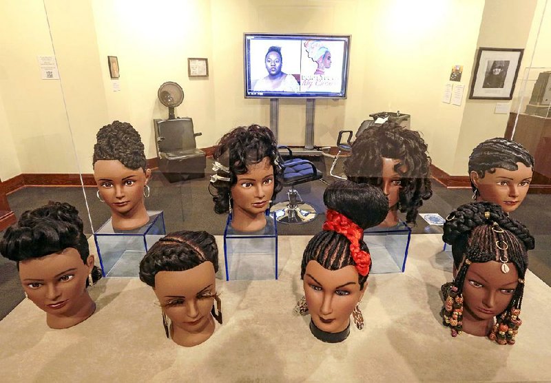 Beauty-school mannequin heads bearing elaborate hairstyles grace “Don’t Touch My Crown” an exhibit at Mosaic Templars Cultural Center as well as drive home the point of the exhibit title: The heads are in a clear case to ensure they can’t be touched by visitors. 