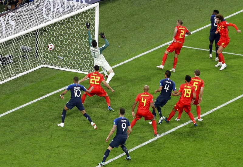 France's Samuel Umtiti, 2nd right, scores the opening goal during the semifinal match between France and Belgium at the 2018 soccer World Cup in the St. Petersburg Stadium in St. Petersburg, Russia, Tuesday, July 10, 2018. (AP Photo/Thanassis Stavrakis)