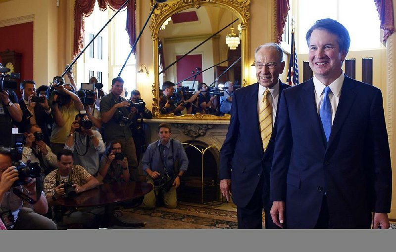 Supreme Court nominee Brett Kavanaugh (right) is escorted by Sen. Charles Grassley, R-Iowa, during a visit with Republican leaders Tuesday on Capitol Hill.   
