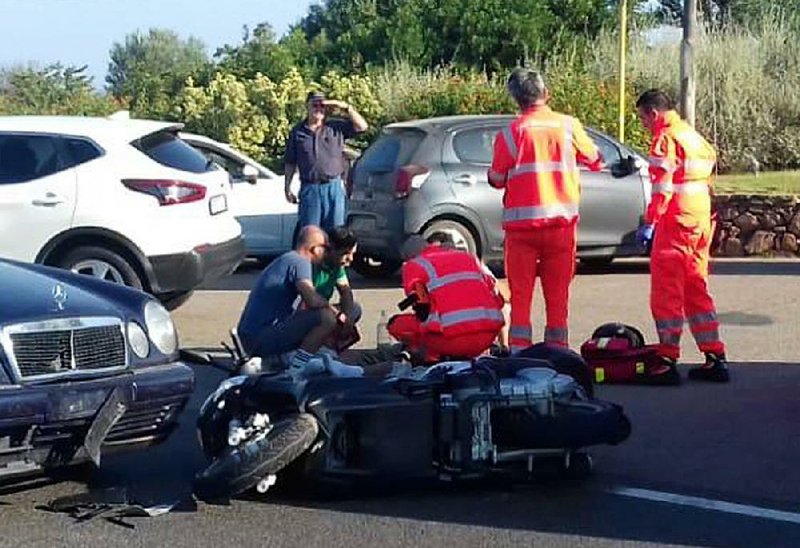 Responders tend to George Clooney at the scene of a car-scooter crash Tuesday on the island of Sardinia.  