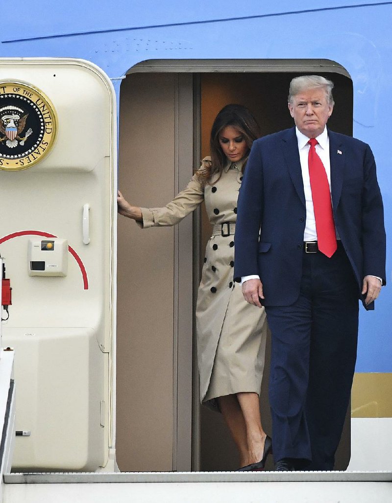 President Donald Trump and his wife, Melania, disembark Air Force One on Tuesday at Melsbroek military airport in Belgium, where Trump is to attend a NATO summit.  