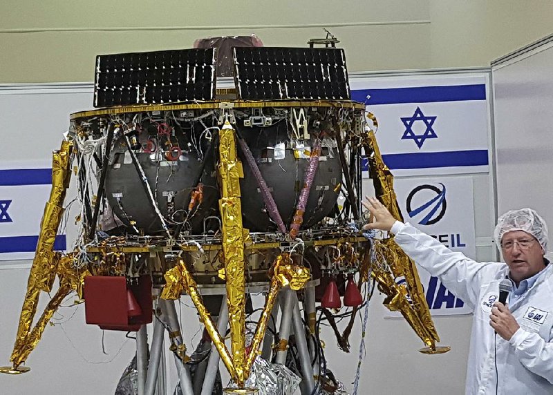 Opher Doron, general manager of Israel Aerospace Industries’ space division, speaks Tuesday next to the SpaceIL lunar module in a special “clean room” where the spacecraft is being developed near Tel Aviv.  