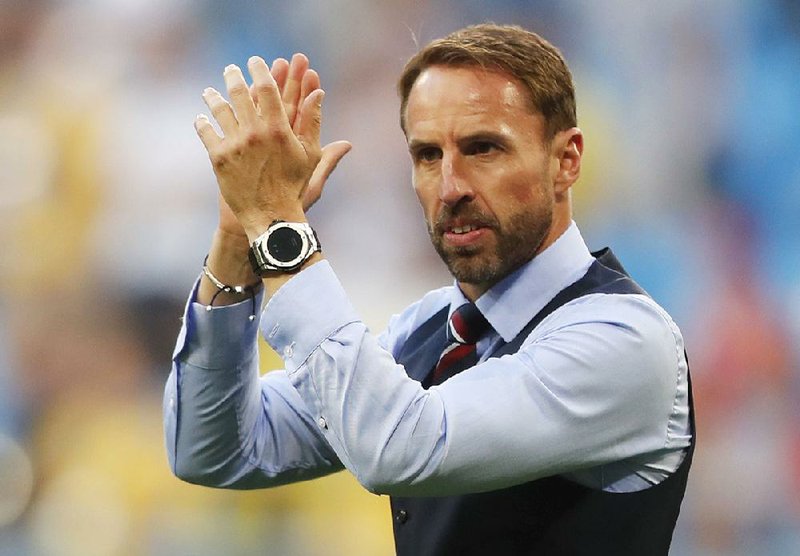 England head coach Gareth Southgate celebrates victory of his team over Sweden during the quarterfinal match between Sweden and England at the 2018 soccer World Cup in the Samara Arena, in Samara, Russia, Saturday, July 7, 2018. 