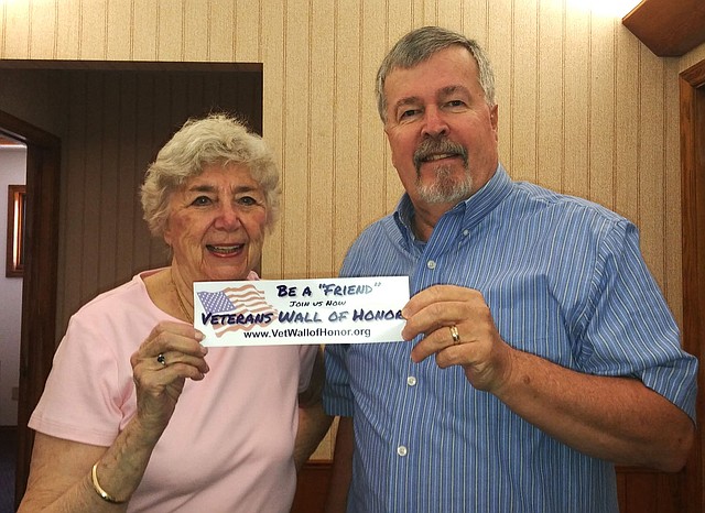 Courtesy photo Julie Storm (left) is an associate member of the Veterans' Wall of Honor, and Douglas Grant is president of the Veterans' Council of Northwest Arkansas. Both are shown holding the "Friends of the Wall of Honor" bumper sticker.
