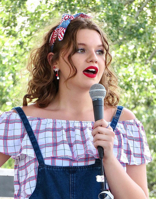 Westside Eagle Observer/RANDY MOLL Brently Wade, 17, answers a question for the judges at the Miss Gentry pageant held Wednesday, July 4, 2018, at the Gentry Freedom Festival. She was selected Miss Gentry at the conclusion of the pageant.