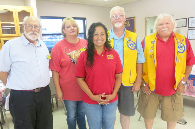 Westside Eagle Observer/SUSAN HOLLAND Jeff Davis (left) poses with new officers of the Gravette Lions Club. They are Melissa Steele, secretary-treasurer; Cela Gaytan, tail twister, Lion tamer and director; Al Blair, president; and Bill Mattler, director. Davis, Lions Club second vice district governor, installed the new officers at the club's July 3 meeting.