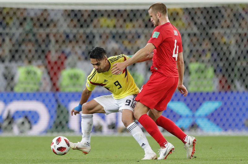 Colombia's Radamel Falcao, left, vies for the ball with England's Eric Dier during the round of 16 match between Colombia and England at the 2018 soccer World Cup in the Spartak Stadium, in Moscow, Russia, Tuesday, July 3, 2018. (AP Photo/Ricardo Mazalan)