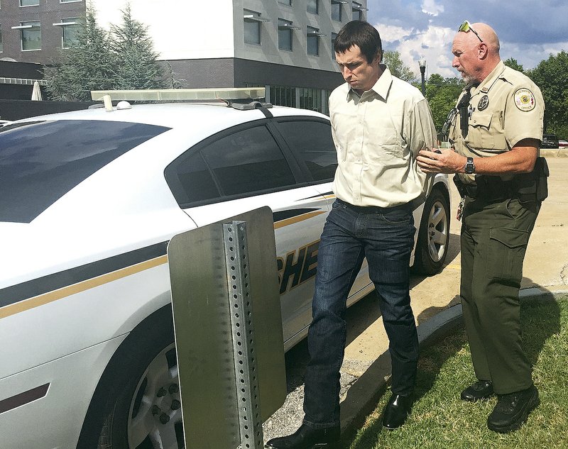 NWA Democrat-Gazette/TRACY M. NEAL Charles Rickman, 31, is taken from Benton County court Tuesday after the first day of his jury trial ends in Bentonville. Rickman is accused of kidnapping and raping a 69-year-old woman.