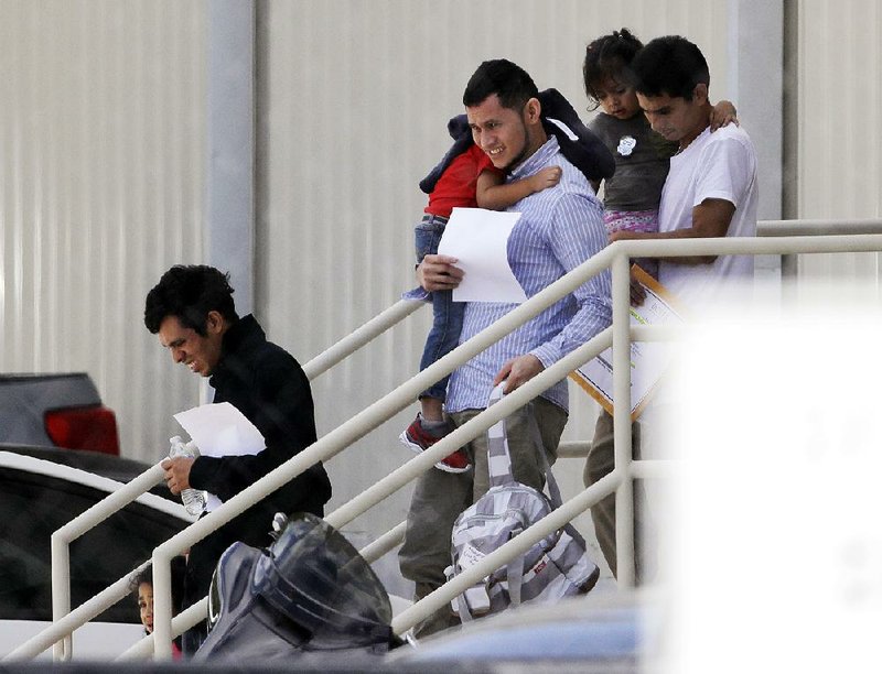 Migrant families leave a U.S. Immigration and Customs Enforcement center after they were reunited Wednesday in San Antonio. After the joyful reunions at centers across the country, parents who had been separated from their children at the border spoke of the trauma of spending months apart and the struggles ahead to stay in the United States. Others still waited to be with their children. 