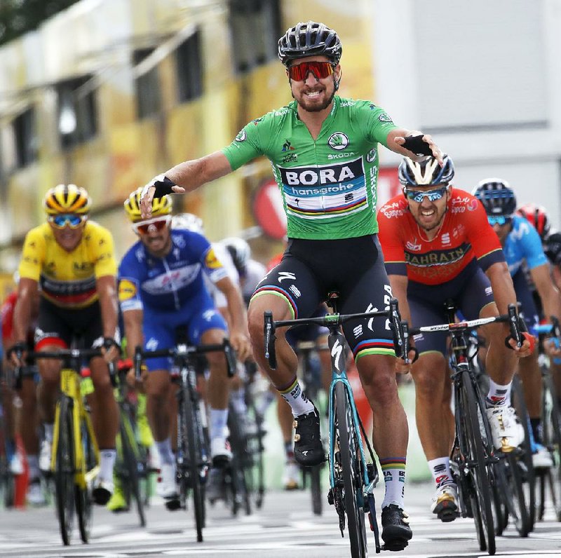 Slovakia’s Peter Sagan (wearing the best sprinter's green jersey), wearing the best sprinter’s green jersey, crosses the finish line in Quimper, France, to win Wednesday’s fifth stage of the Tour de France. Belgium’s Greg van Avermaet maintained the overall lead by 2 seconds over American Tejay van Garderen.