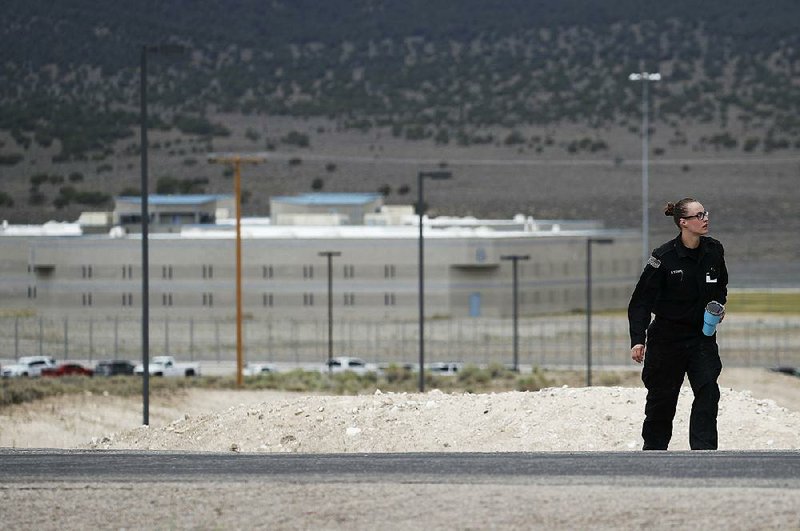 A corrections officer patrols Wednesday near the entrance to Ely State Prison, home of Nevada’s execution chamber.  