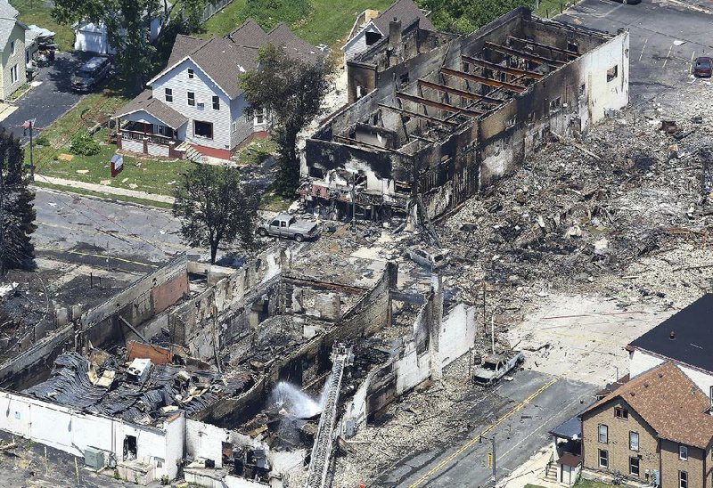 The site of natural gas explosion that killed a firefighter in Sun-Prairie, Wis., is seen from the air Wednesday. 