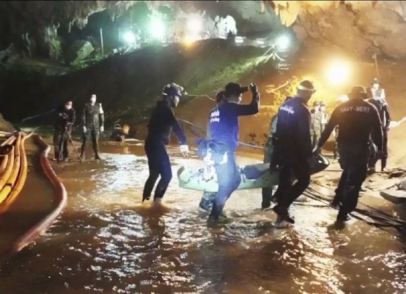 An undated photo released Wednesday by Thai navy SEALS shows rescuers holding an evacuated boy inside the Tham Luang Nang Non cave. 