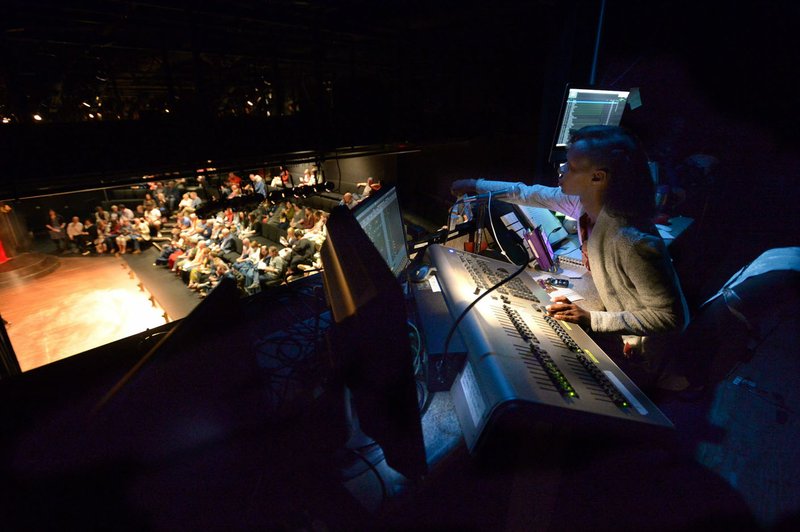 NWA Democrat-Gazette/ANDY SHUPE Shannon Jones, stage manager for TheatreSquared, operates the sound and lighting boards May 24 during a performance of The Hound of the Baskervilles in the Nadine Baum Studios in Fayetteville.
