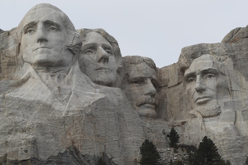 FILE - In this Dec. 9, 2016, file photo, the faces of the presidents that make up the Mount Rushmore monument are shown near Keystone, S.D. The PBS host Geoffrey Baer is back this summer with new episodes of his series "10 That Changed America" focusing on streets, monuments and marvels, including one show that gives the surprising inside story behind icons like the Statue of Liberty and Mount Rushmore. (AP Photo/David Zalubowski, File)