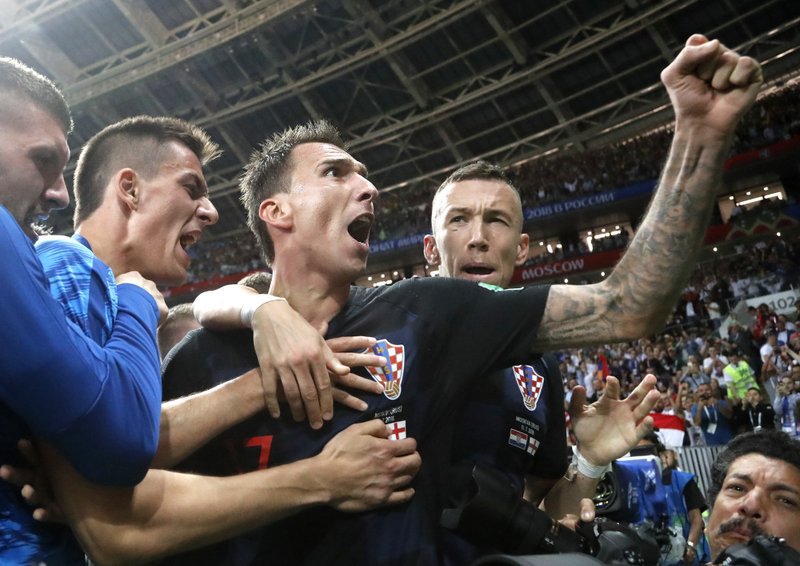 The Associated Press FIRST TRIP TO FINALS: Croatia's Mario Mandzukic, center, celebrates after scoring his side's winning goal for a 2-1 lead against England in the semifinals of the 2018 FIFA World Cup in Moscow, Russia, Wednesday. Maddzukic's goal came in the 109th minute as the Croats took their first lead in the second overtime period.
