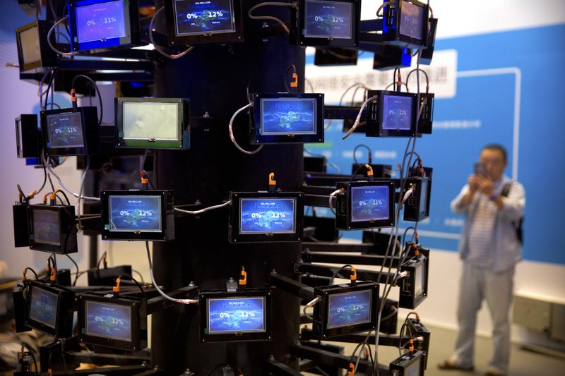  In this Sept. 12, 2017, file photo, an attendee looks at a digital representation of network connectivity at a vendor's display booth at the China Internet Security Conference in Beijing. A California-based security-research firm said Wednesday, July 11, 2018, that it found evidence that an elite Chinese government-linked hacking team has penetrated computer systems belonging to Cambodia's election commission, opposition leaders and media in the months leading up to Cambodia's July 29 election. (AP Photo/Mark Schiefelbein, File)