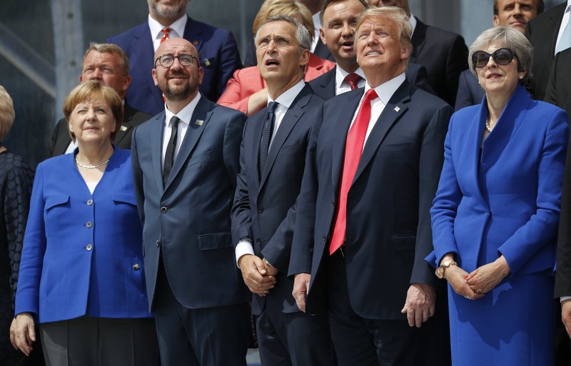 From left to right, German Chancellor Angela Merkel, Belgium's Prime Minister Charles Michel, NATO Secretary General Jens Stoltenberg, President Donald Trump, and Britain's Prime Minister Theresa May, look up in sky during a ceremonial fly-over ahead of the opening ceremony of the NATO (North Atlantic Treaty Organization) summit, at the NATO headquarters in Brussels, Wednesday, July 11, 2018.(AP Photo/Pablo Martinez Monsivais)