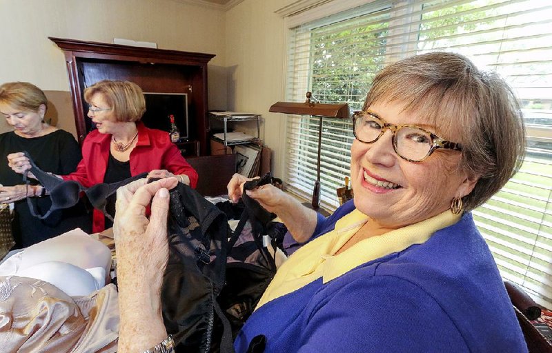 Donna Norvell Smith (right) founded BRAS (Bras Received And Shared) with a group of friends to collect the undergarments for women in shelters. Ruthie Hiett (left) and Carole Canino (center) help sort donated bras.  