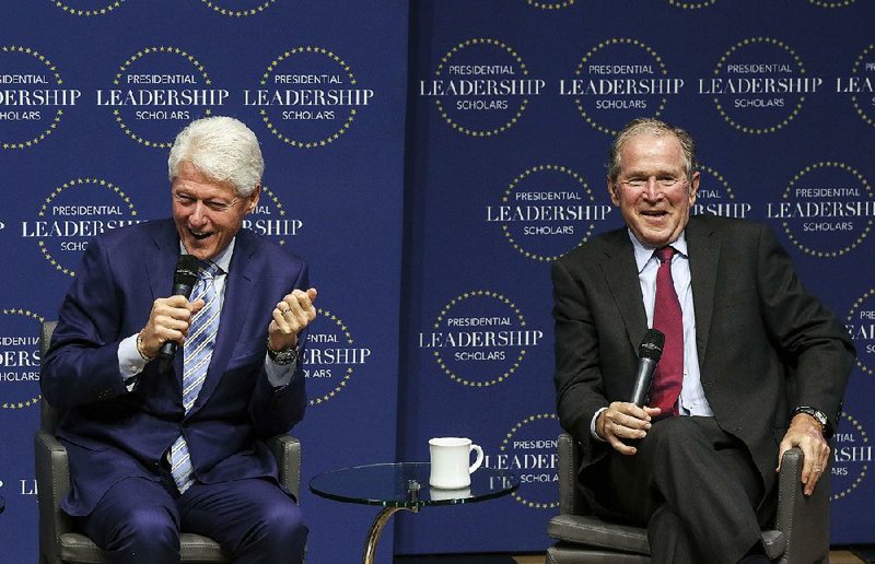 Former U.S. Presidents Bill Clinton and George W. Bush share a laugh during the graduation ceremony of the 2018 Presidential Leadership Scholars Program.  