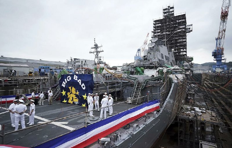 The USS John S. McCain, officially named Thursday for U.S. Sen. John McCain, sits in dry dock as it undergoes repairs at the U.S. naval base in Yokosuka, Japan.  