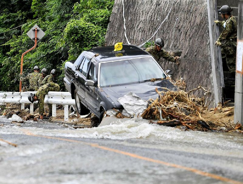 Japanese troops search Thursday for people missing after heavy rains in Hiroshima triggered flooding and landslides.  