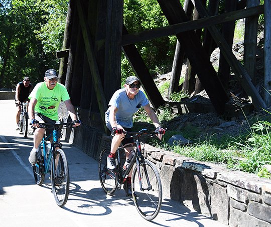 The Sentinel-Record/Grace Brown GROUP RIDE: Bicyclists make their way down the Hot Springs Creek Greenway Trail on Wednesday. Outdoor activities are part of what draws millions of visitors to Garland County each year, according to a new report.