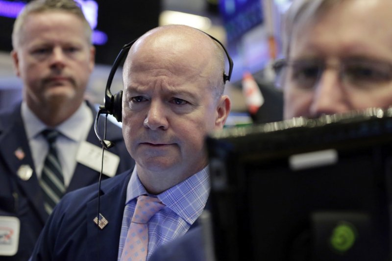 Trader Patrick Casey, center, works on the floor of the New York Stock Exchange, Thursday, July 12, 2018. Stocks are opening higher as technology companies rally. (AP Photo/Richard Drew)