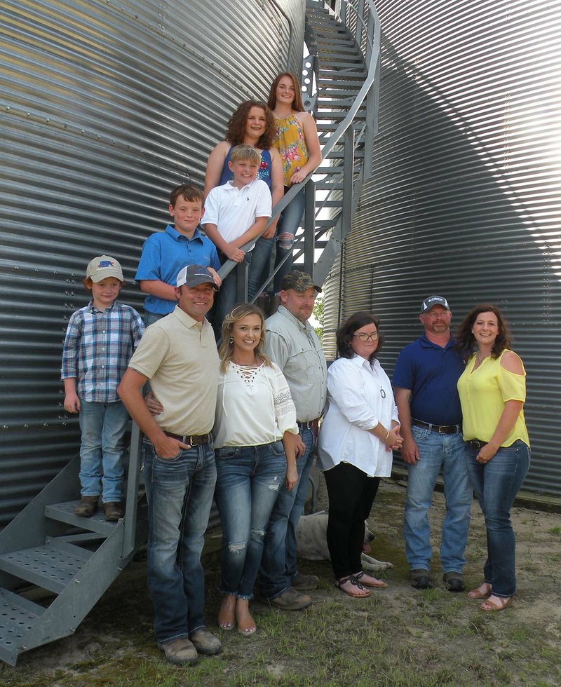 Members of WKW Farms of Swifton operate 3,000 acres of row crops in Jackson County. Three families form the farm partnership. Members of the families, gathered around one of the grain storage bins, include, on the stairs, from top, Madison Walker, Elizabeth Walker, Cagen Walker, Jesse King and Jake King; and front row, from left, Rob Walker, Andrea Walker, Greg King, Laura King, John Walker and Mandy Walker.