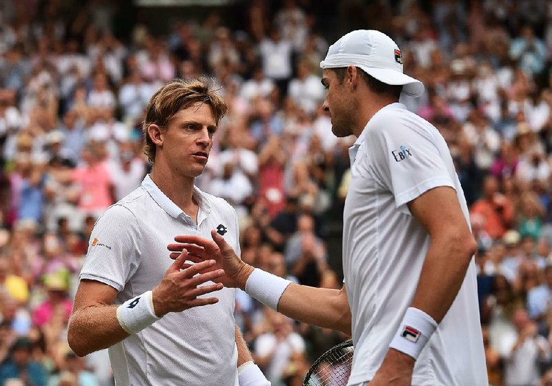 Kevin Anderson (left) of South Africa defeated American John Isner in the men’s Wimbledon semifinals Friday in the longest match ever at Centre Court. Anderson won the fifth set 26-24.  