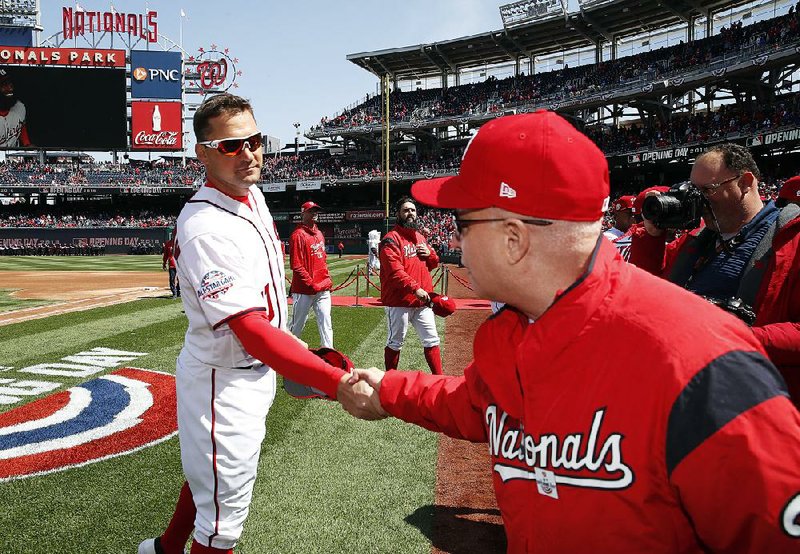 Washington Nationals first baseman Ryan Zimmerman (left) shakes hands with team owner Mark Lerner on opening day. The Nationals, who relocated to Washington D.C. from Montreal in 2005, are hosting the city’s first all-star game since 1969.  
