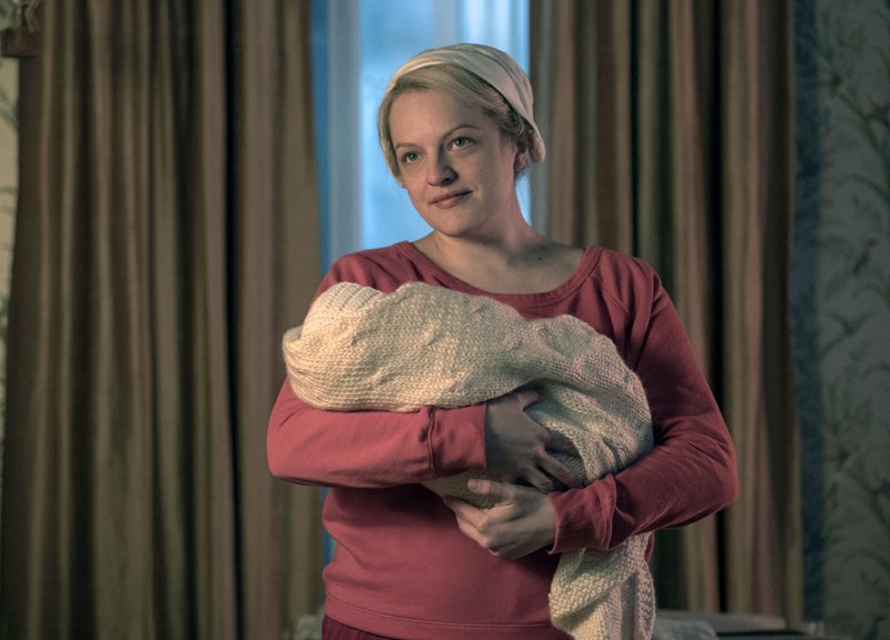 The Associated Press HANDMAID AND BABY: This image released by Hulu shows Elisabeth Moss in a scene from "The Handmaid's Tale." Moss was nominated Thursday for an Emmy for outstanding lead actress in a drama series. The 70th Emmy Awards will be held on Monday, Sept. 17.