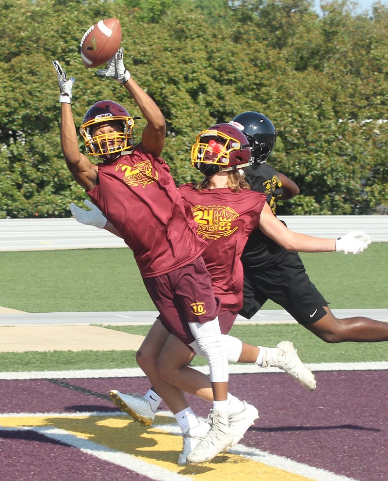 The Sentinel-Record/Richard Rasmussen PICK-OFF: Lake Hamilton's Tre Darrough, left, intercepts a pass in the endzone with teammate Brandon Braughton while playing Hot Springs during pool play of the Live Like Bryce 7-on-7 tournamant Friday.