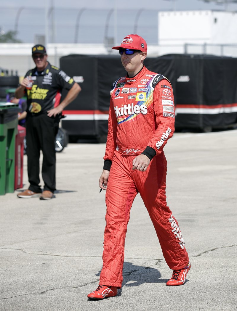 Kyle Busch walks to his garage during a practice session for the NASCAR Cup Series auto race at Chicagoland Speedway in Joliet, Ill., Saturday, June 30, 2018. (AP Photo/Nam Y. Huh)