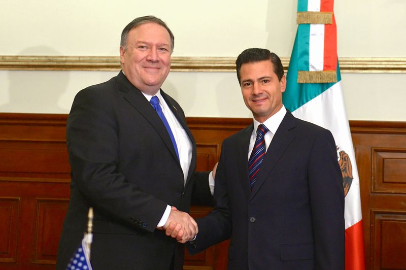 In this photo released by Mexico's Presidential Press Office, Secretary of State Mike Pompeo (left) and Mexico's President Enrique Pena Nieto, pose for a photo at Los Pinos presidential residence in Mexico City, Friday, July 13, 2018.