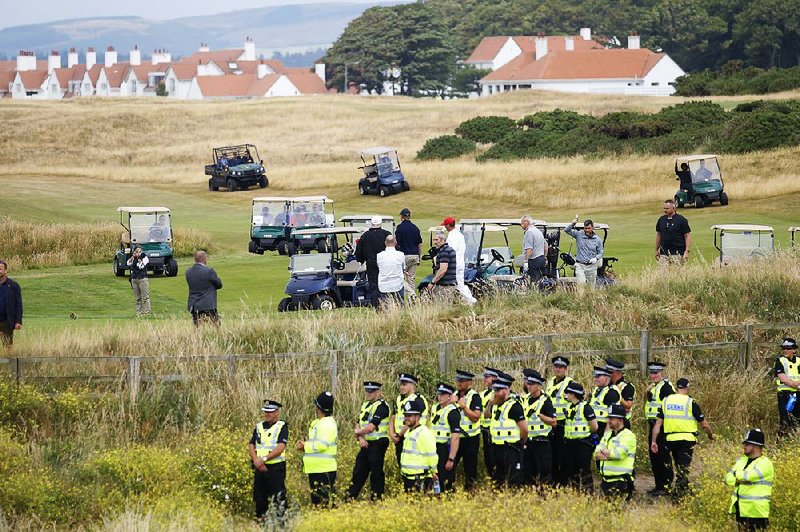 Security is tight Saturday as President Donald Trump plays golf at Trump Turnberry, a luxury resort in Turnberry, Scotland. Nearby protesters chanted “No Trump, no KKK, no racist USA” as he teed off Saturday. Thousands more demonstrated against the U.S. president in Edinburgh.  
