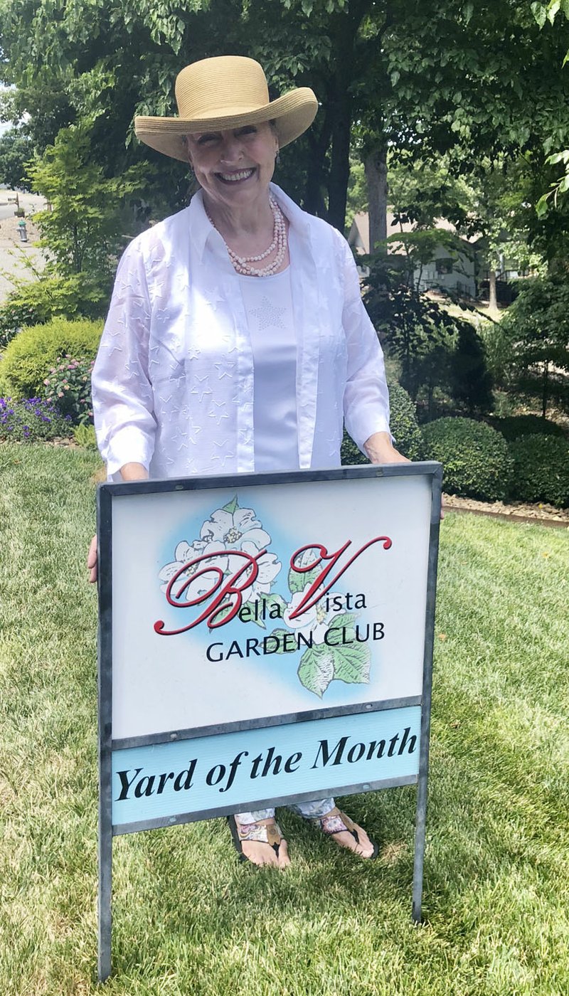 Courtesy photo Winners of the Bella Vista Garden Club June Yard of the Month are Kathy Curtis (pictured) and her husband Jerry of 45 Cargill Drive in Bella Vista. The Bella Vista Garden Club is promoting and rewarding exemplary yard care in Bella Vista and recognizes neighbors who demonstrate above-average efforts in maintaining their property, which contributes to the overall appearance of the community at large. All homes and businesses in Bella Vista are eligible. Nominations are for the front and side yards jointly. One yard is chosen each month by members of the club who choose the yard that best exemplifies uniqueness, beauty and curb appeal. Nominate a yard by email to bvyardofthemonth@gmail.com or call (479) 268-8325. Provide the address and the homeowners name if known. All nominations will be in the running for future recognition.