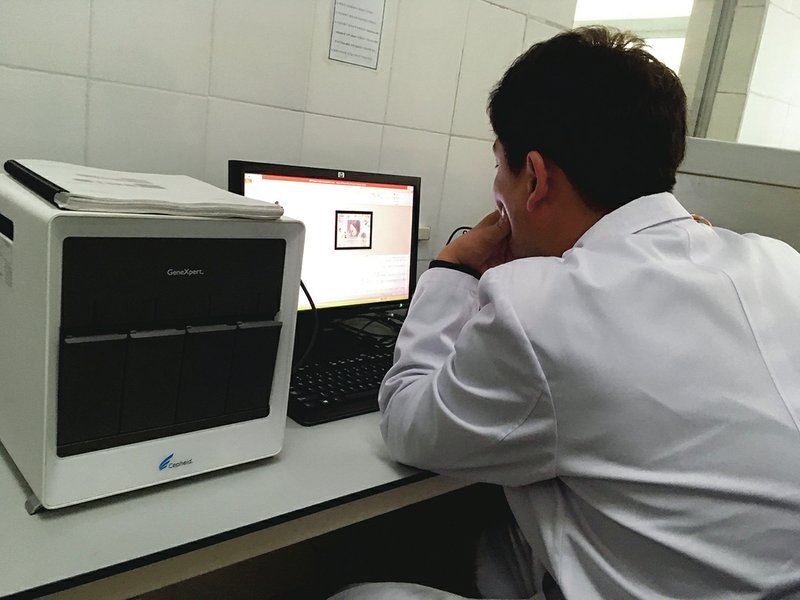 The Associated Press LAPTOP WORK: In this May 7 photo, a staffer works at a laptop next to an American-made GeneXpert machine used to diagnose tuberculosis at the National Tuberculosis Reference Laboratory in Pyongyang, North Korea. The machines at the lab can't be used because officials can't procure the materials they need to operate them. Despite a mood of detente following the summit between U.S. President Donald Trump and North Korean leader Kim Jong Un in June, ongoing sanctions are keeping life-saving medicines from North Korean tuberculosis patients and could fan a regional epidemic.
