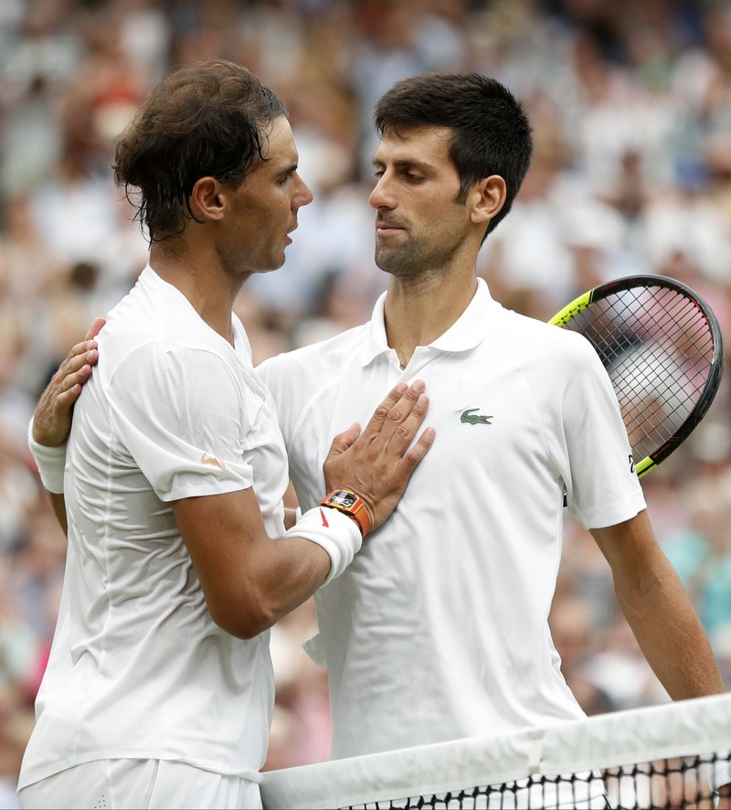 The Associated Press MEETING AT THE NET: Novak Djokovic, right, meets Rafael Nadal at the net after defeating him in the men's singles semifinal match Saturday at the Championships, Wimbledon in London.