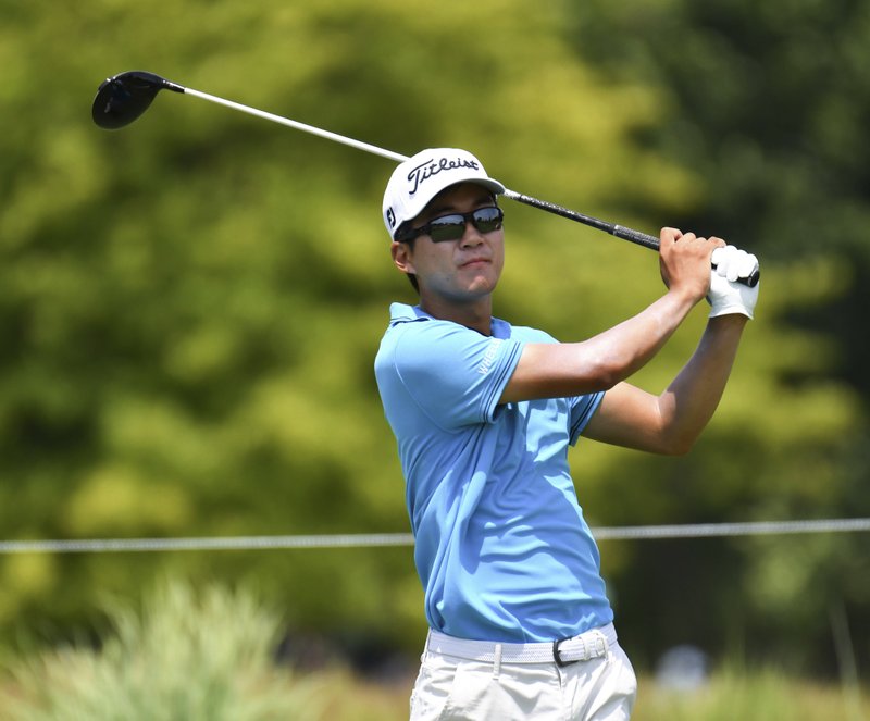 The Associated Press TEEING OFF: Michael Kim tees off on the ninth hole during the first-round of the John Deere Classic golf tournament Thursday in Silvis, Ill. Kim led by four shots following Friday's rain delays.