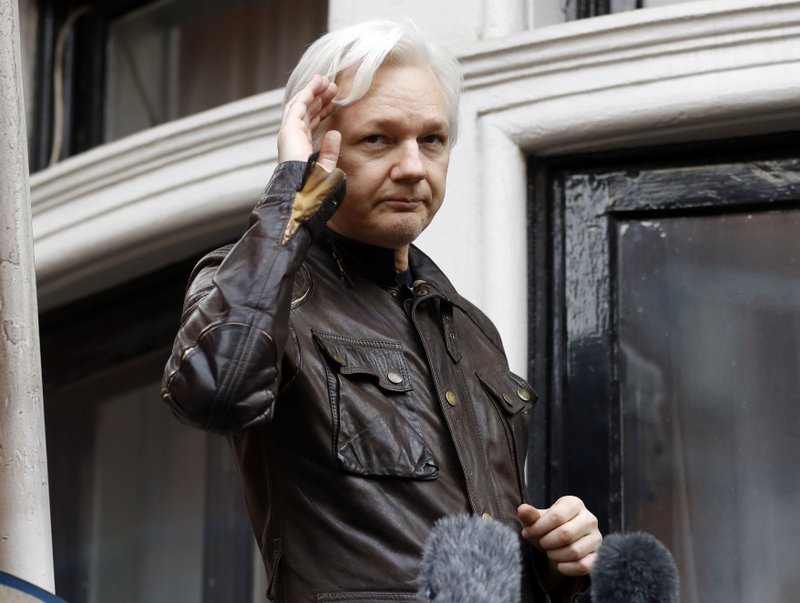 FILE - In this May 19, 2017 file photo, WikiLeaks founder Julian Assange greets supporters from a balcony of the Ecuadorian embassy in London. The Justice Department's indictment Friday, July 13, 2018 of 12 Russian military intelligence officers for U.S. election hacking undermine denials by WikiLeaks founder Julian Assange that the Russian government was the source of stolen Democratic Party emails published by the anti-secrecy organization. (AP Photo/Frank Augstein, File)