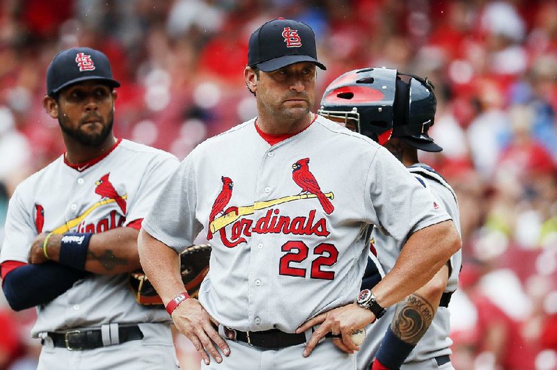 Former St. Louis Cardinals manager Mike Matheny (22) looks back toward the dugout after relieving starting pitcher Carlos Martinez in the fourth inning of a baseball game against the Cincinnati Reds, Sunday, June 10, 2018, in Cincinnati. 