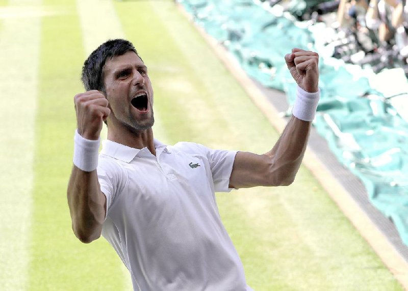 Novak Djokovic celebrates winning the Wimbledon men’s championship against Kevin Anderson on Sunday in London. It is Djokovic’s 13th major trophy, the fourth-highest total in the history of men’s tennis.  