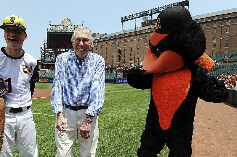 Hall of Fame third baseman Brooks Robinson, center, laughs with the Orioles bird before the Baltimore Orioles and Miami Marlins baseball game, Sunday, June 17, 2018, in Baltimore. 