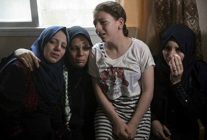 Relatives of 15-year-old Ameer al-Nimra, who was killed along with another teenager on Saturday in an Israeli airstrike on Gaza, mourn during his funeral in the family home Sunday in Gaza City.  