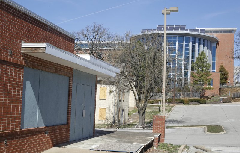File photo/NWA Democrat-Gazette/DAVID GOTTSCHALK The Old City Hospital and the Fayetteville Public Library are seen March 5. An event will be held Tuesday to kick off the library's expansion project.