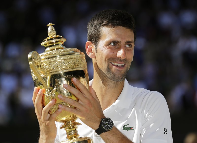 The Associated Press NO DOUBT: Novak Djokovic holds the trophy after defeating Kevin Anderson Sunday in the men's singles final match at the Championships, Wimbledon in London.