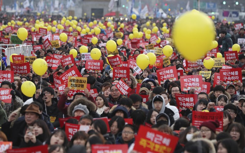 FILE - In this Dec. 17, 2016 file photo, protesters shout slogans during a rally against the impeached South Korean President Park Geun-hye in downtown Seoul, South Korea. The letters read &quot;Arrest, Park Geun-hye.&quot; South Korean President Moon Jae-in has ordered an investigation after a lawmaker disclosed a document drafted by a military intelligence unit that showed plans to deploy troops in Seoul amid massive protests last year to oust his conservative predecessor, now in prison on corruption charges. (AP Photo/Lee Jin-man, File)