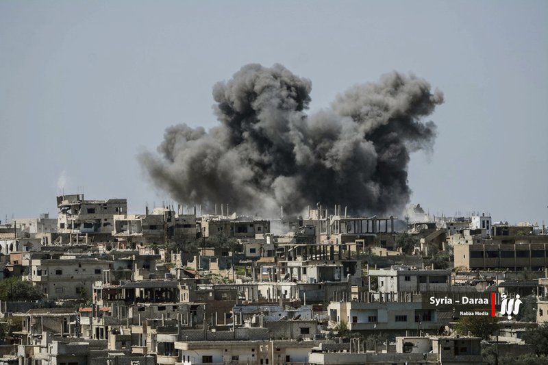  This Thursday, July 5, 2018 file photo provided by Nabaa Media, a Syrian opposition media outlet, shows smoke rising over buildings that were hit by Syrian government forces bombardment, in Daraa province, southern Syria.  (Nabaa Media via AP, File)